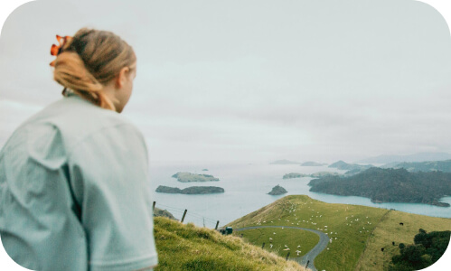 New Zealander up at the top of some rolling hills in Northland overlooking bays